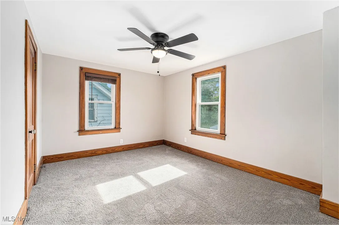 Spare room with carpet floors and ceiling fan