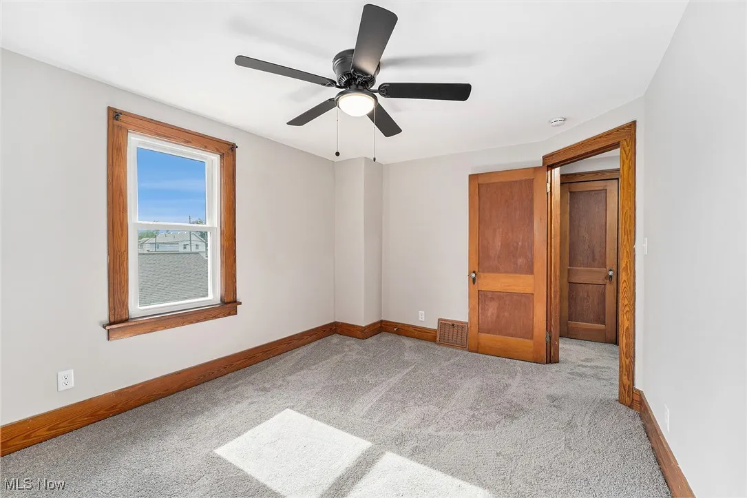 Unfurnished bedroom with carpet floors and a ceiling fan