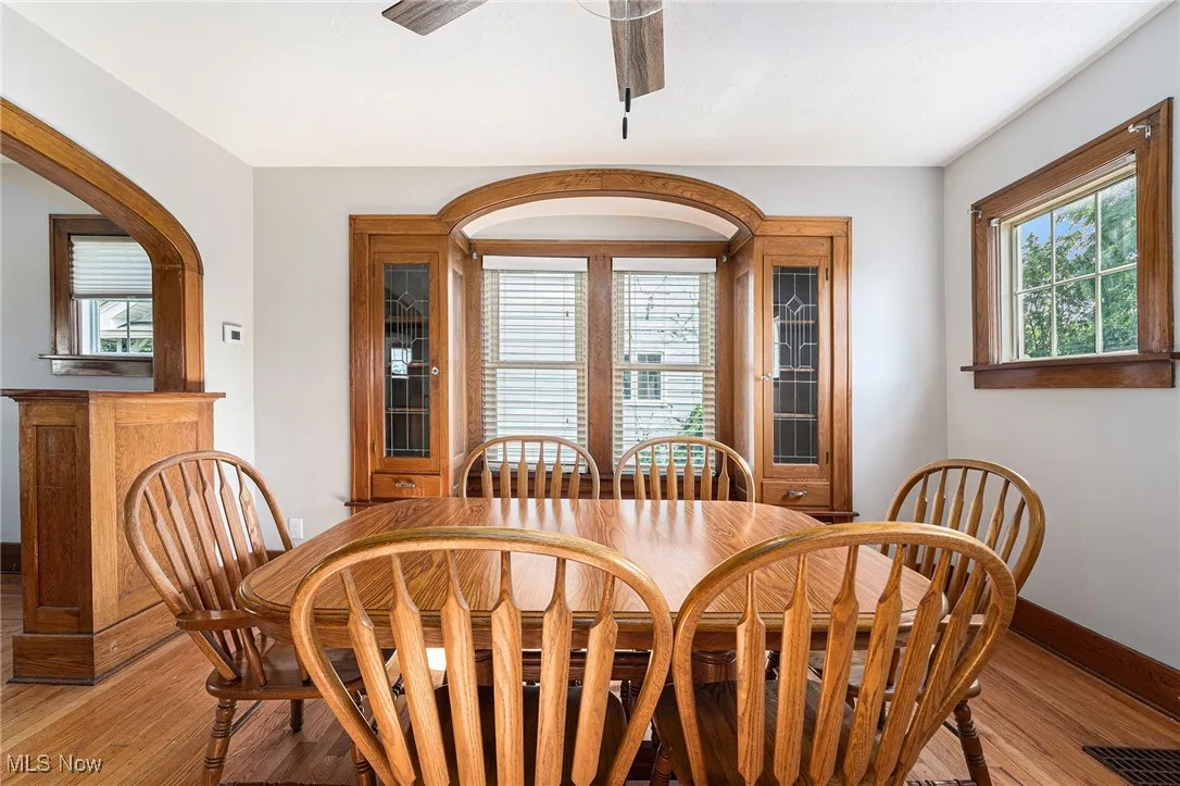 Dining room with a ceiling fan and light wood finished floors