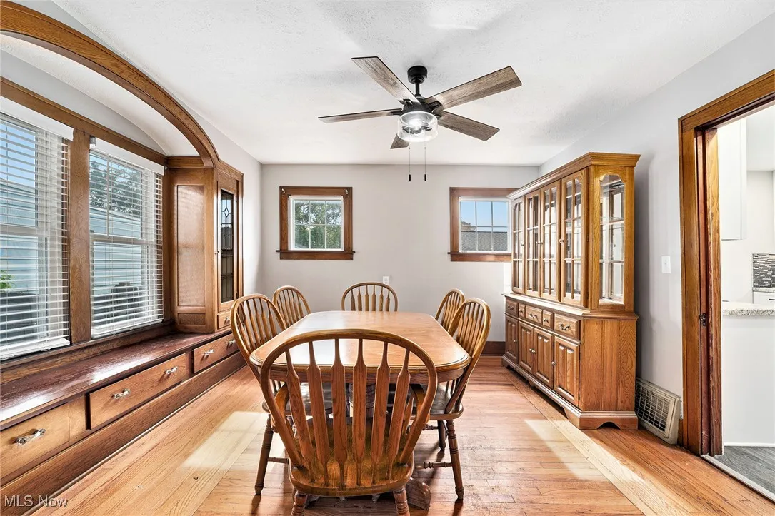 Dining room featuring light wood-type flooring, ceiling fan, and healthy amount of natural light