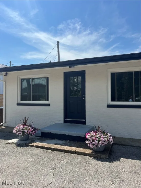Entrance to property with brick siding