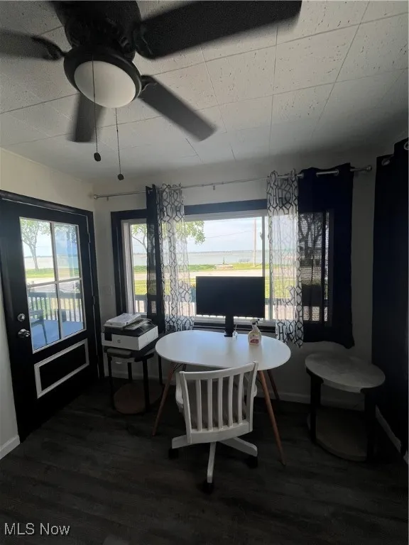 Dining room featuring ceiling fan, wood finished floors, and healthy amount of natural light