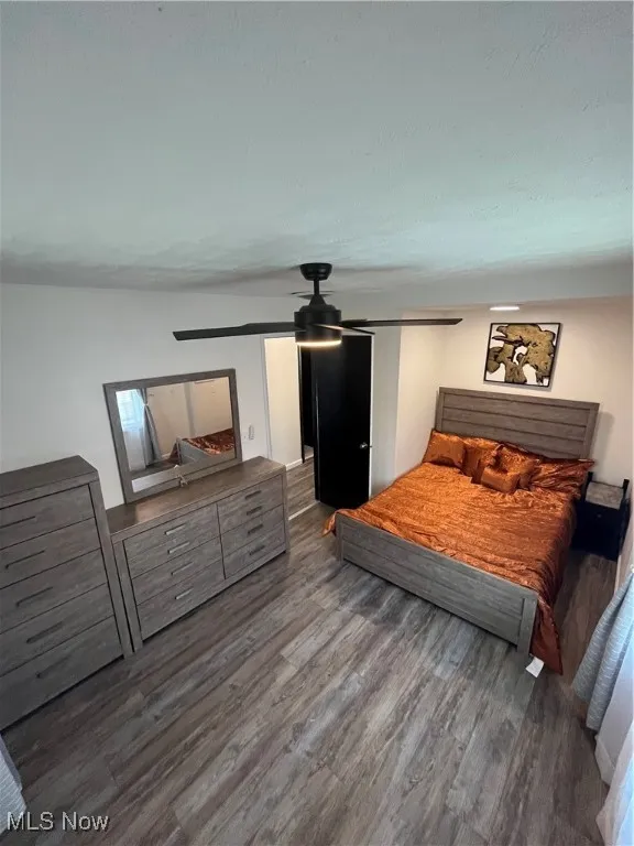 Bedroom with wood finished floors and a ceiling fan