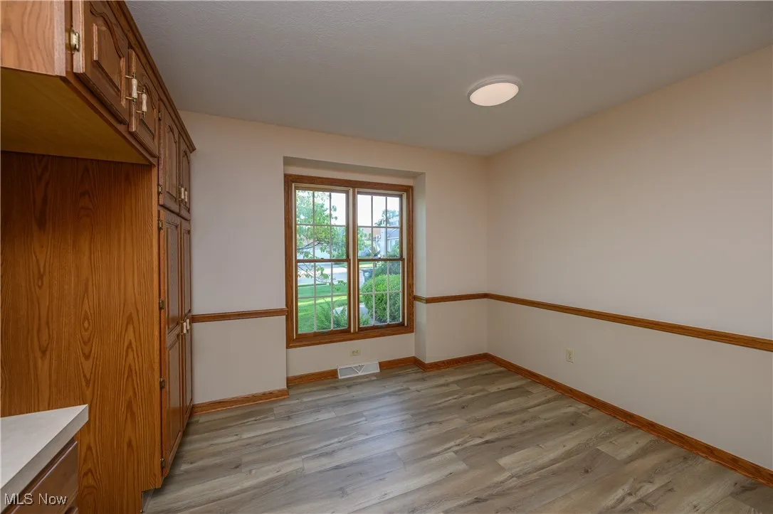 Spare room with light wood-style flooring and baseboards