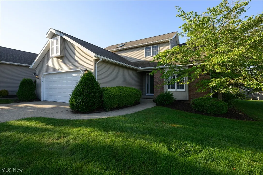 Traditional-style home featuring concrete driveway, a front yard, and an attached​​‌​​​​‌​​‌‌​‌‌​​​‌‌​‌​‌​‌​​​‌​​ garage