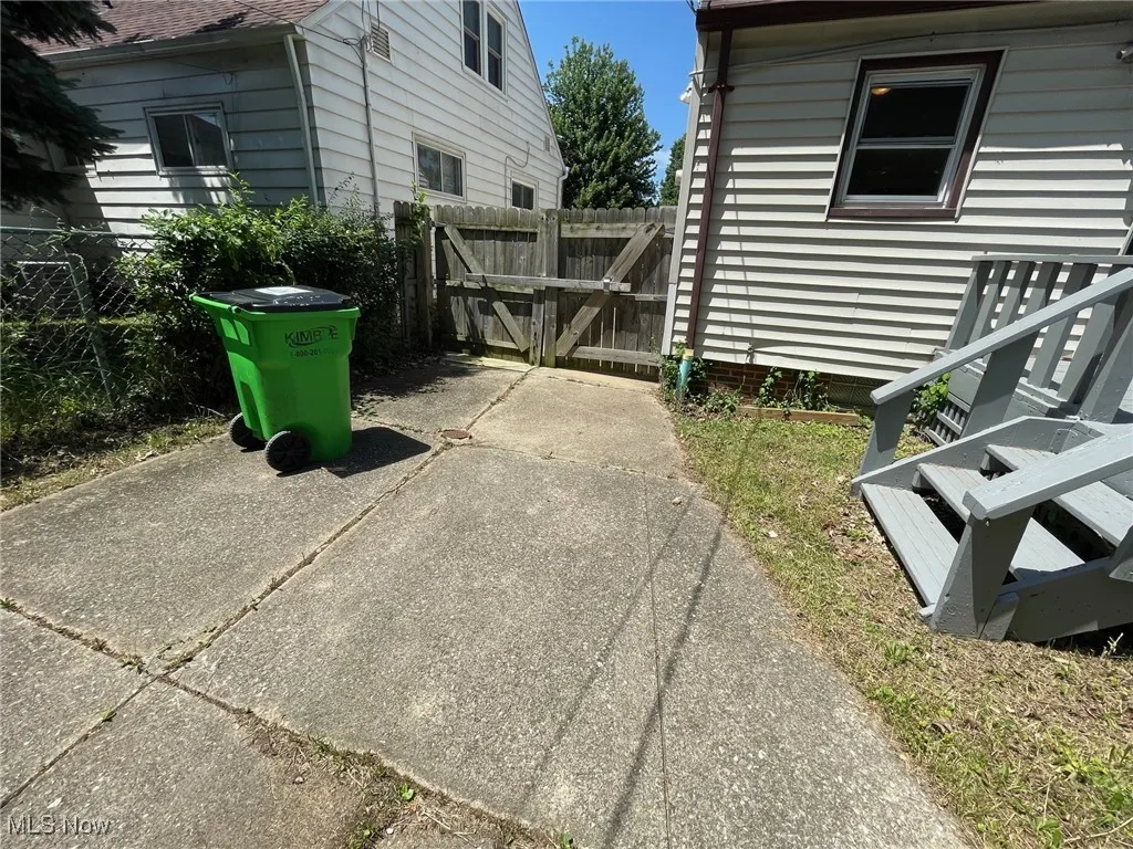 Between the garage and the house
