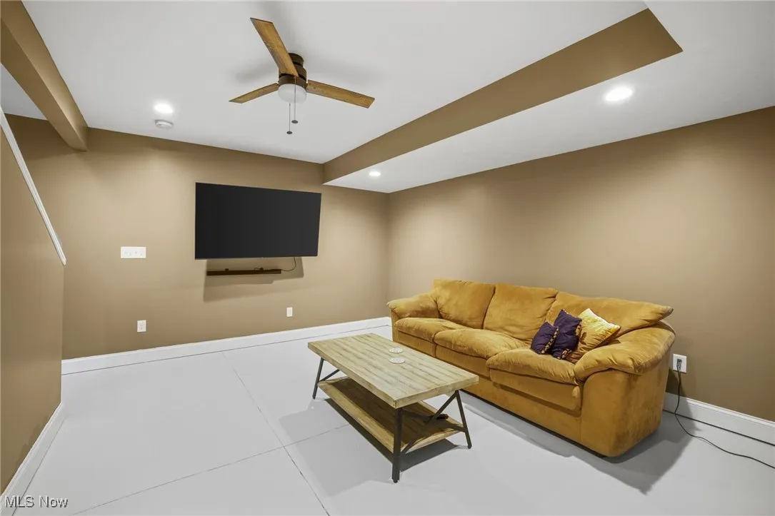 Living area with recessed lighting and a ceiling fan