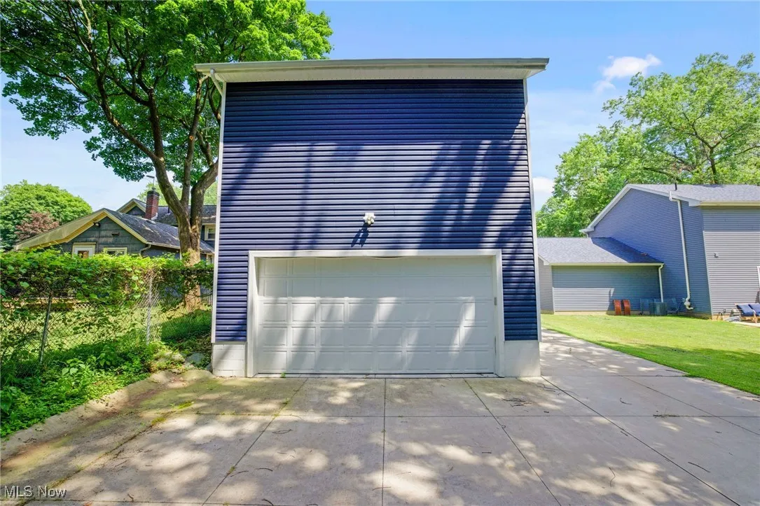 Garage featuring concrete driveway