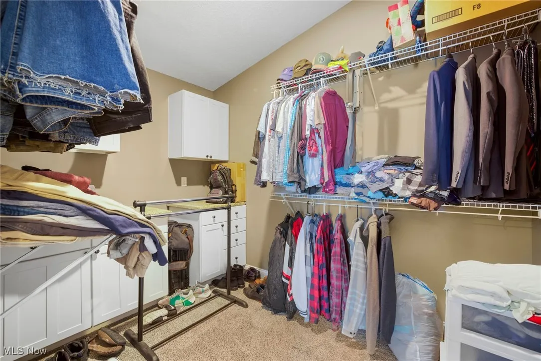 Spacious closet with carpet floors
