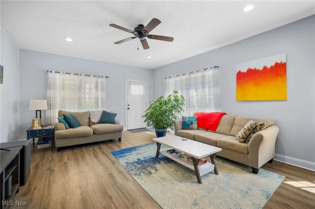Living area featuring wood finished floors, ceiling fan, and recessed lighting