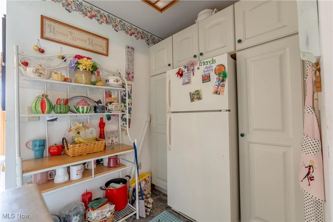 Kitchen with freestanding refrigerator