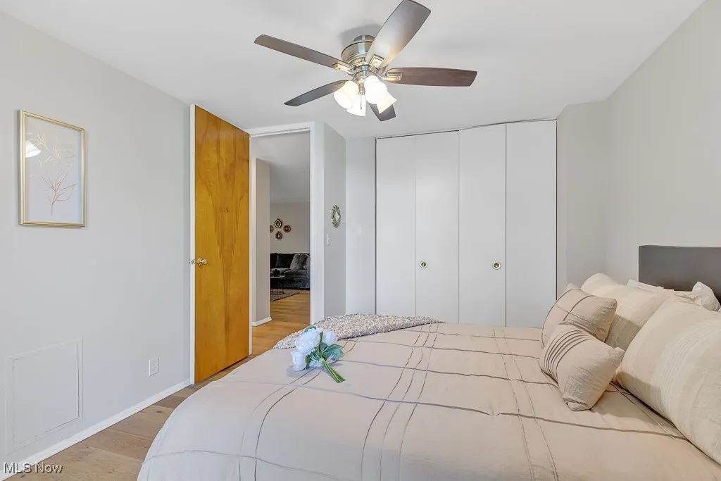 Bedroom featuring light wood-style flooring, a closet, and ceiling fan