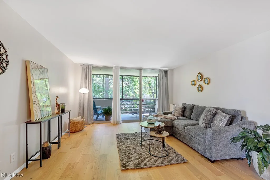Living room with light wood-style flooring and expansive​​‌​​​​‌​​‌‌​‌‌​​​‌‌​‌​‌​‌​​​‌​​ windows