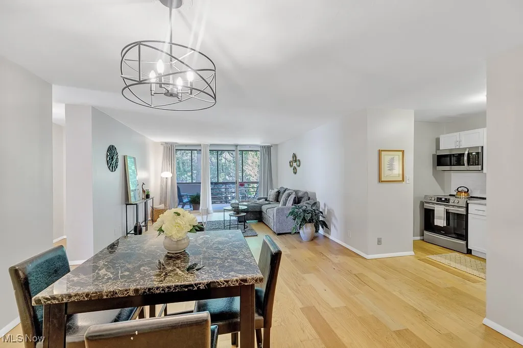 Dining space featuring a chandelier and light wood-type flooring