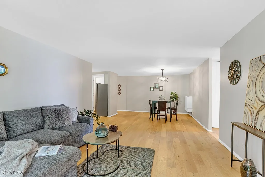Living room with light wood-type flooring and baseboards