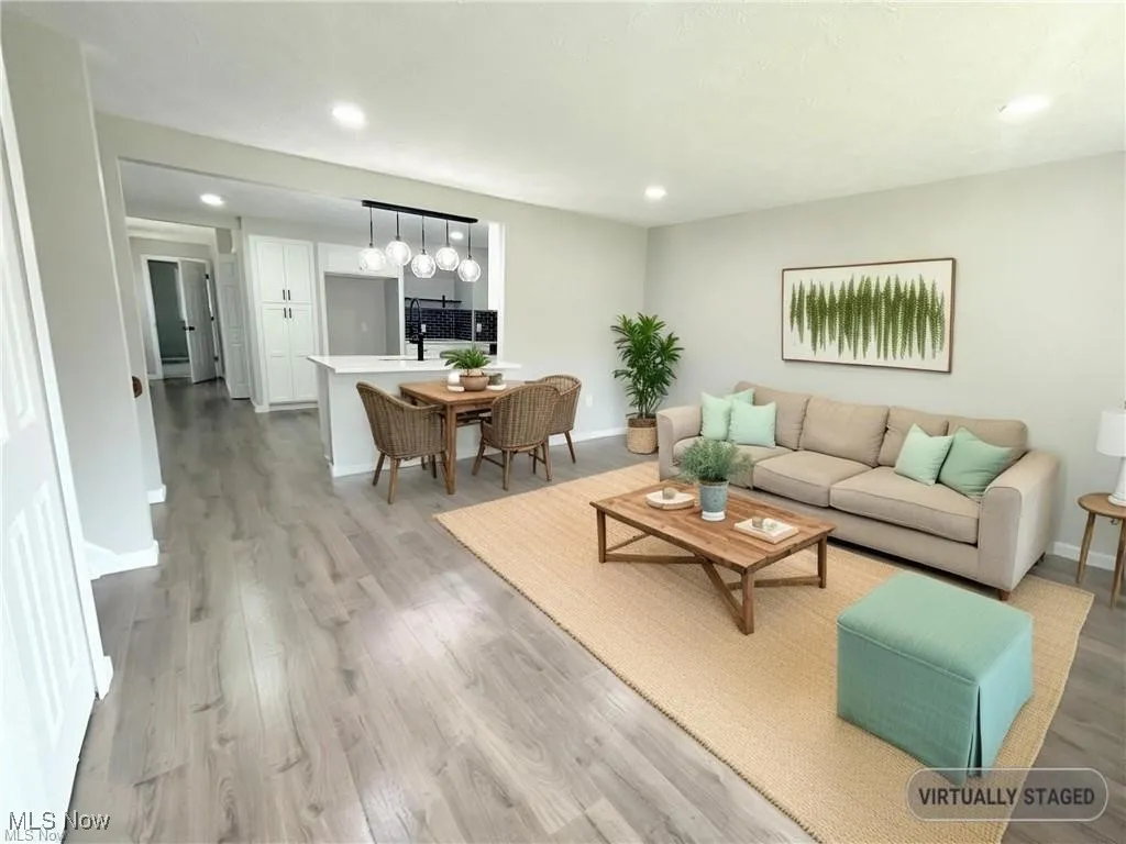 Living area featuring recessed lighting, light wood-style flooring, and a chandelier