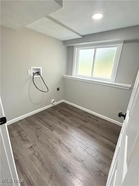 Washroom with dark wood-style floors, hookup for a washing machine, electric dryer hookup, and recessed lighting