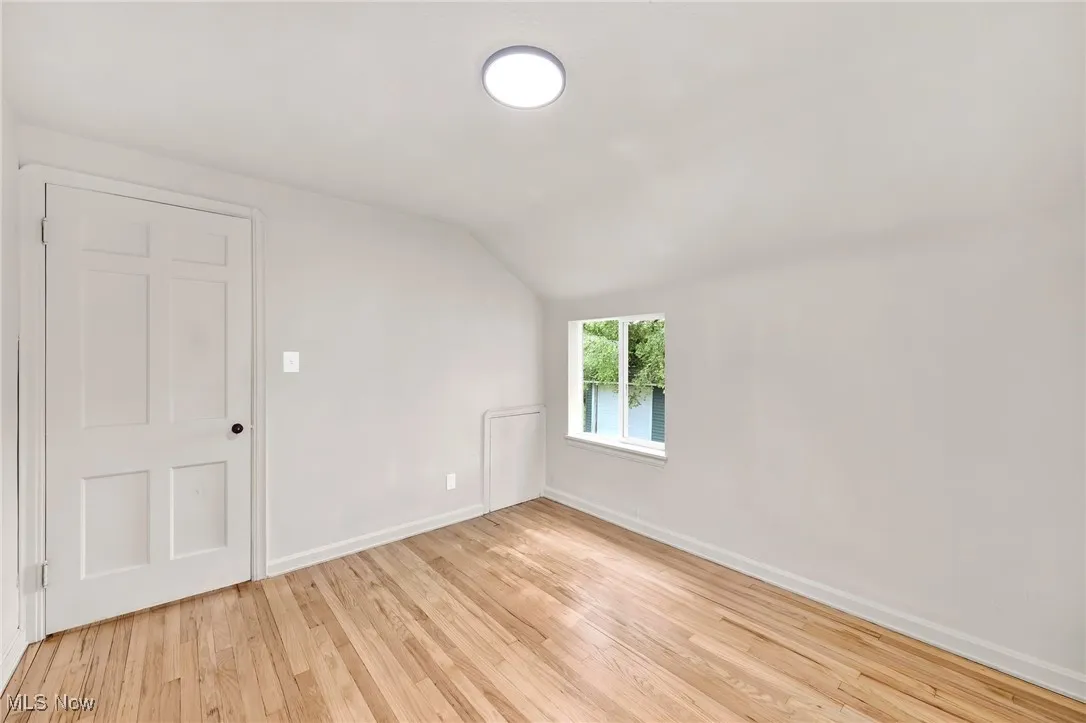 Bonus room featuring vaulted ceiling and light wood-type flooring