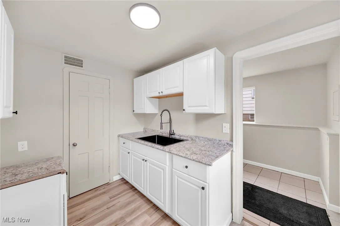 Kitchen with a sink and white cabinets