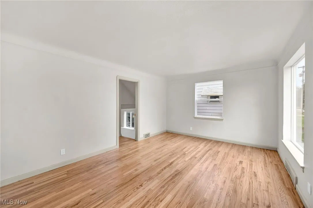 Spare room with light wood-type flooring and baseboards