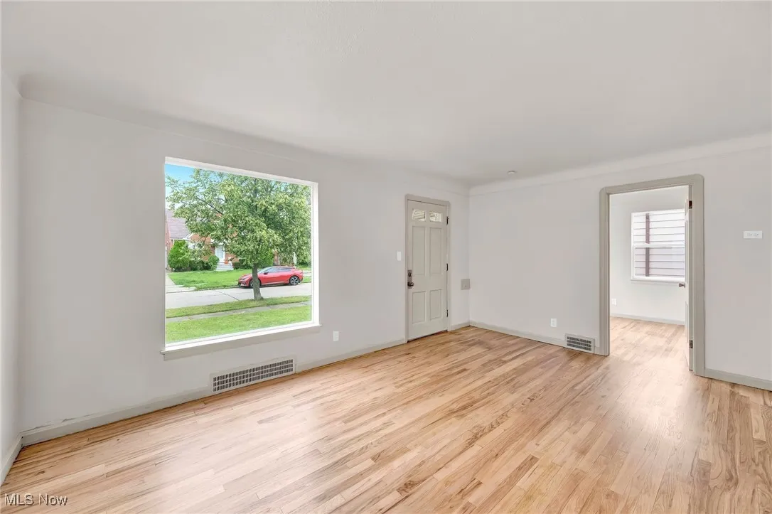 Spare room featuring wood finished floors and baseboards