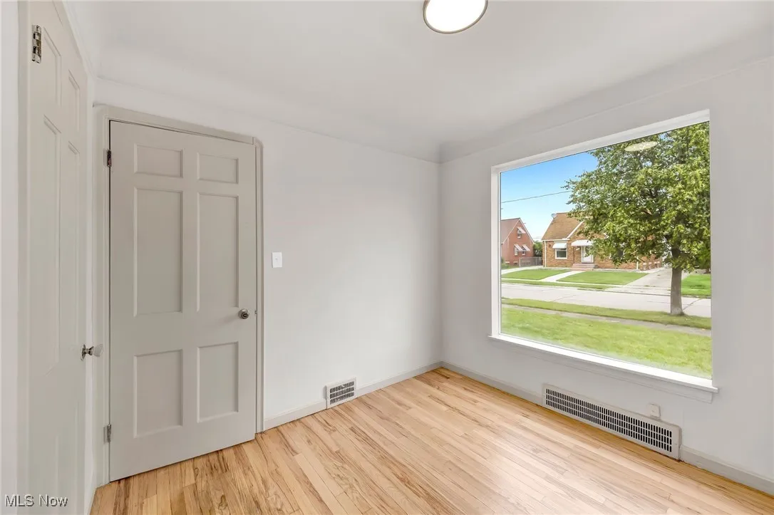 Unfurnished room featuring baseboards and light wood-style floors
