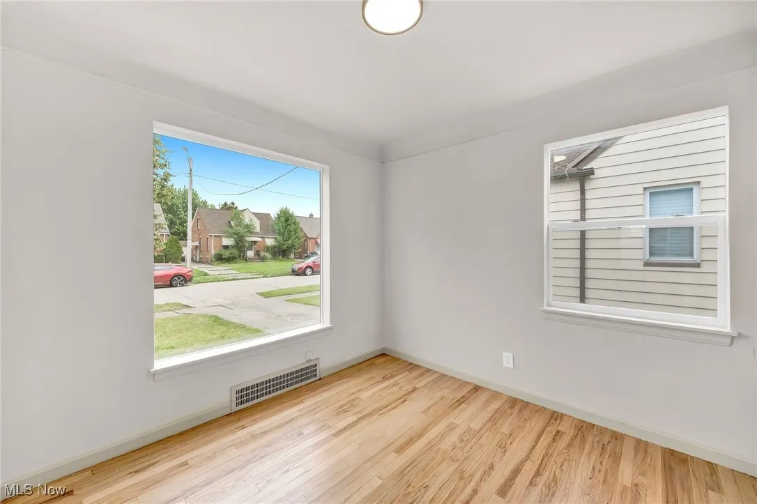 Spare room with wood finished floors and baseboards