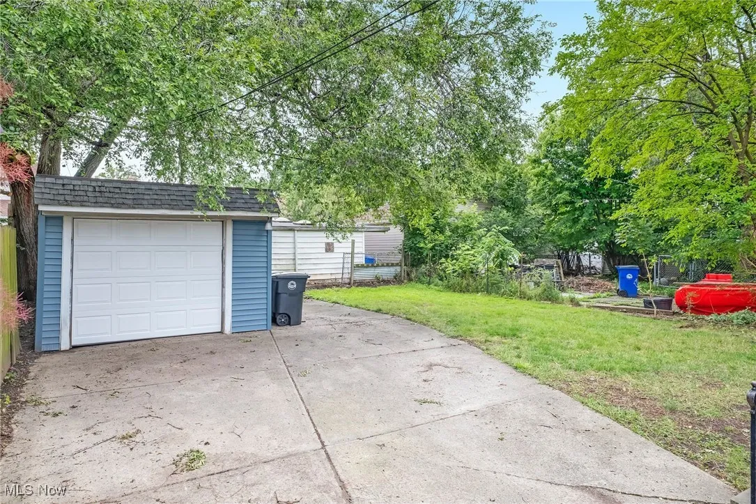 Detached garage with concrete driveway