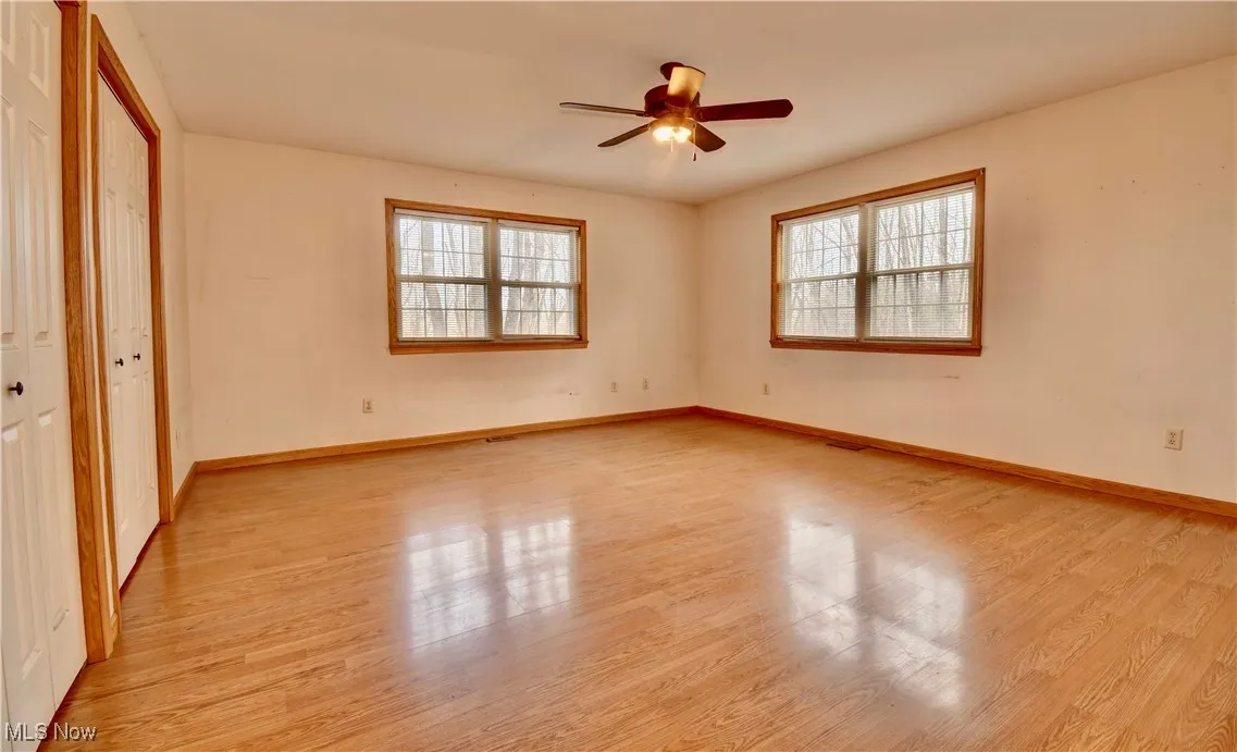 Unfurnished bedroom featuring light wood finished floors and ceiling fan