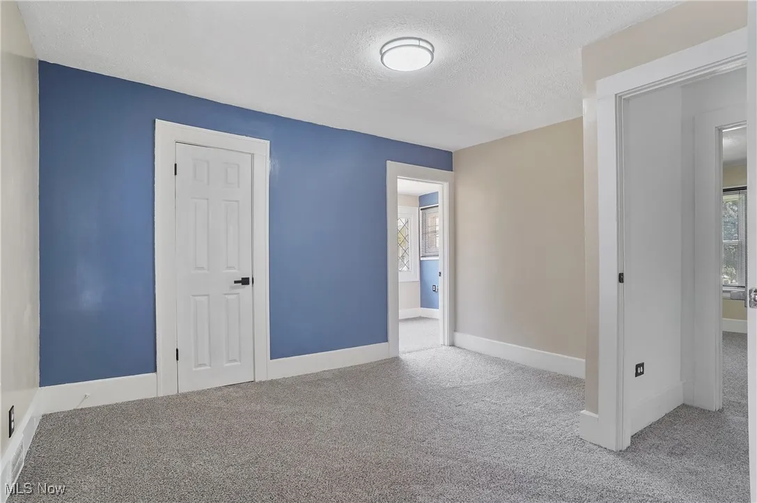 Unfurnished bedroom featuring carpet floors and a textured ceiling