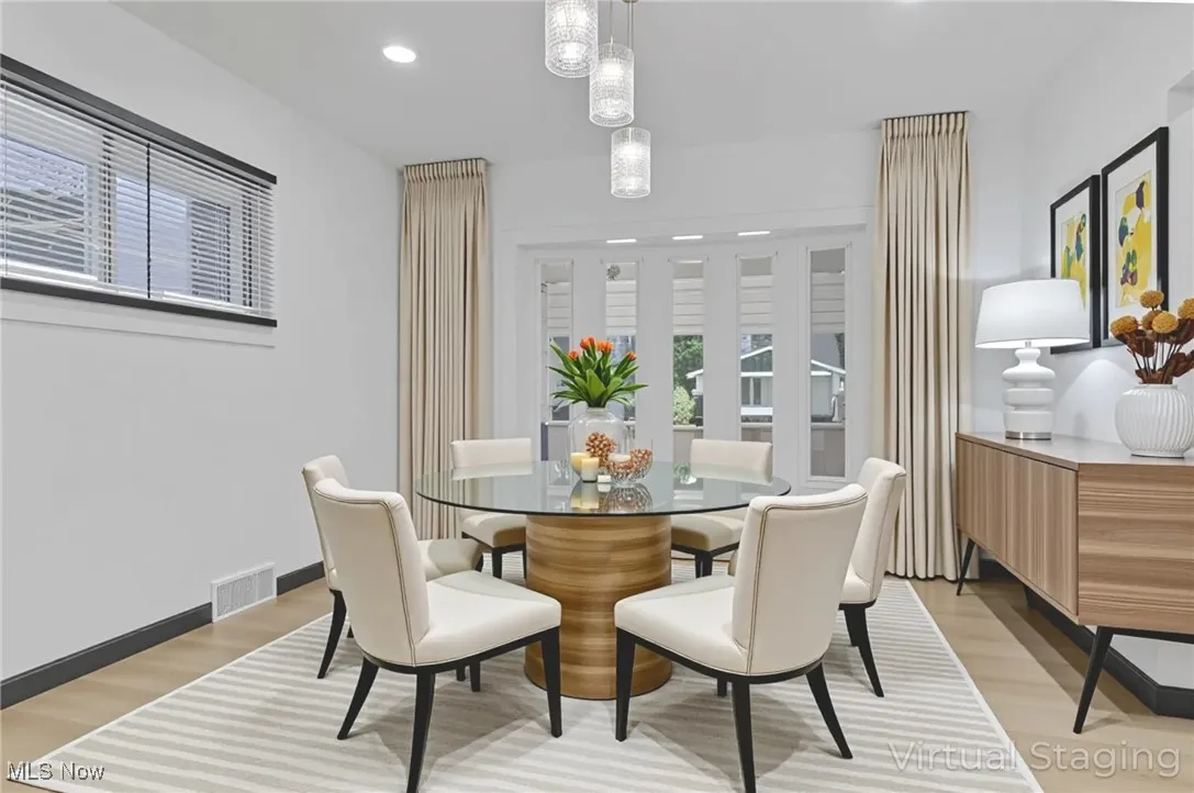 Dining space with light wood-style flooring and recessed lighting