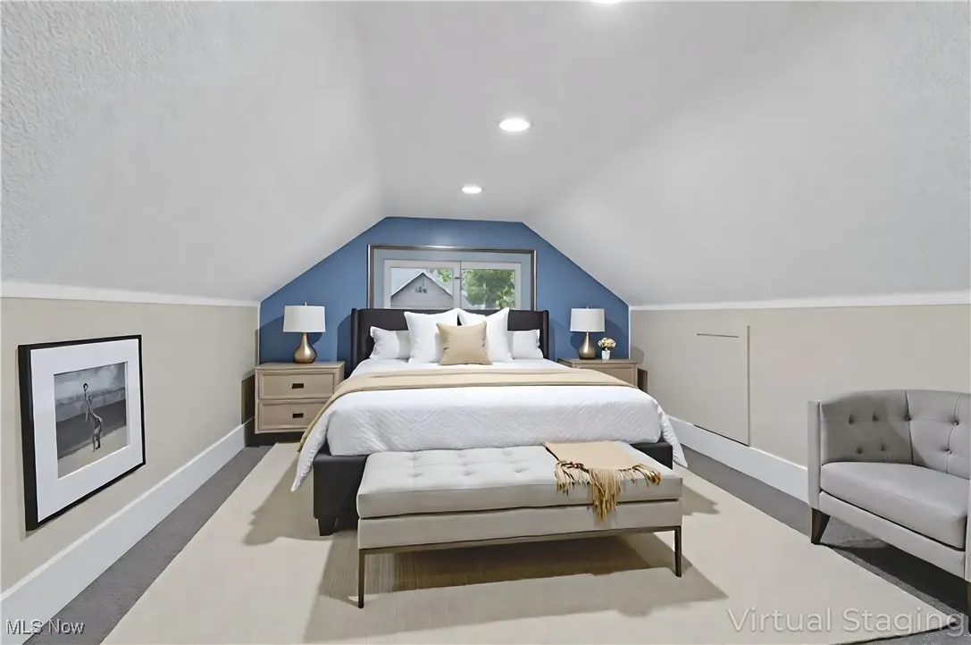 Bedroom featuring baseboards and lofted ceiling