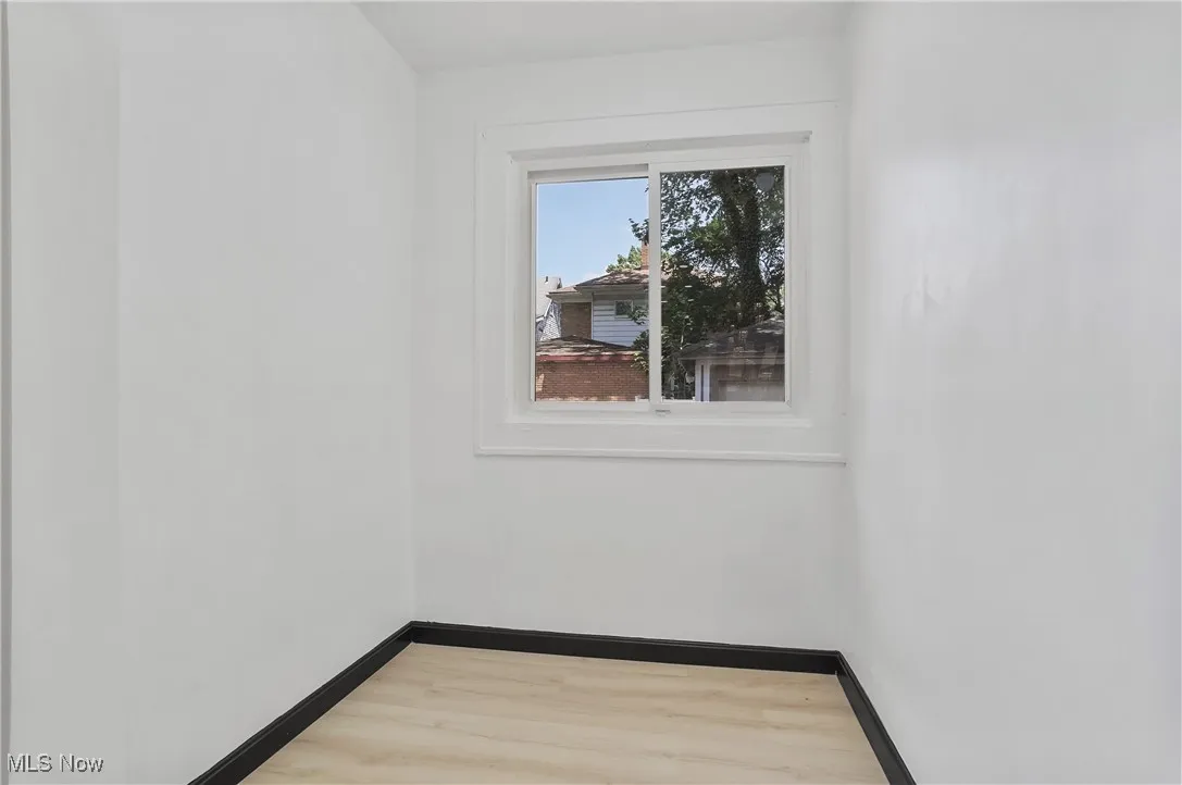 Unfurnished room with light wood finished floors and baseboards
