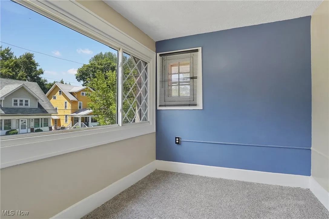 Carpeted empty room featuring baseboards
