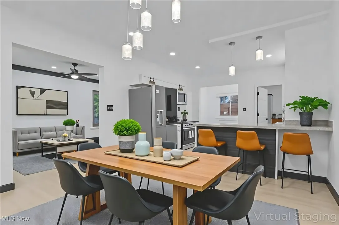 Dining area with light wood-style floors, recessed lighting, and ceiling fan