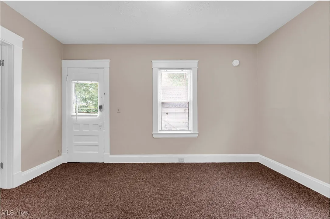 Entryway featuring dark carpet