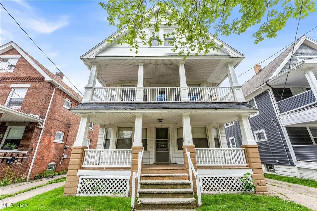 View of front of house featuring a balcony and covered porch