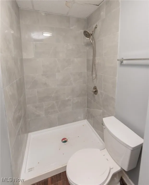 Bathroom with a shower stall and wood finished floors