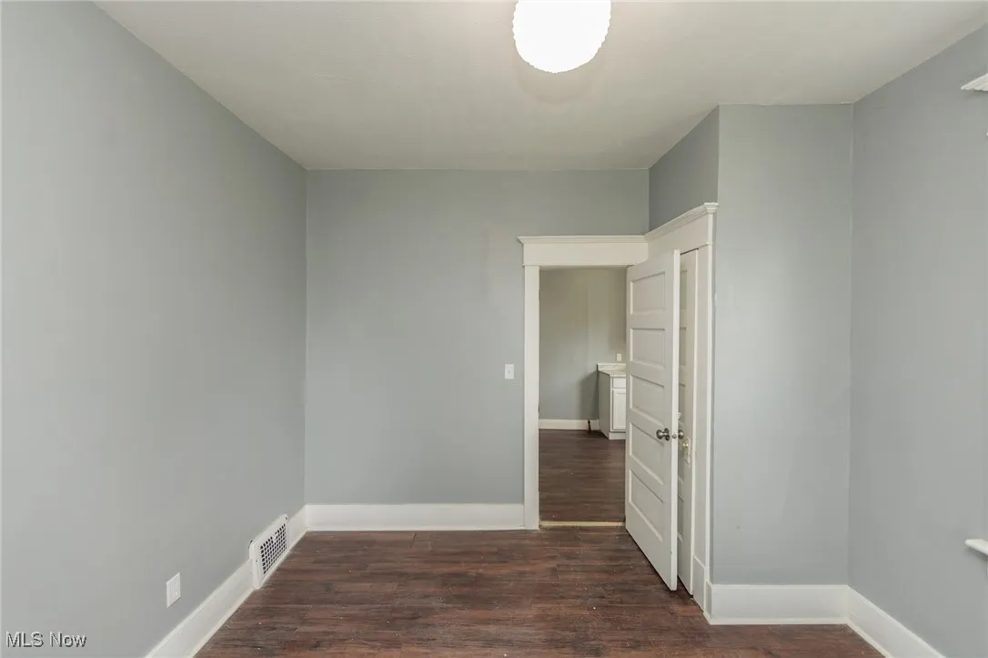 Empty room with wood finished floors and baseboards