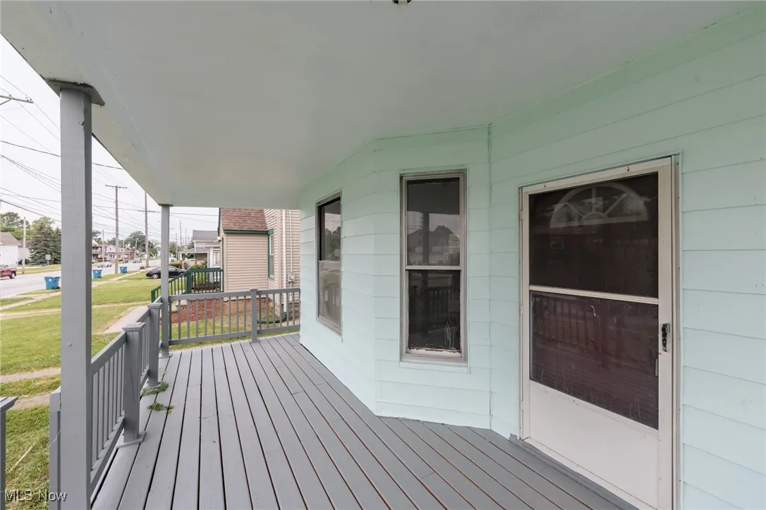 Wooden porch with a yard