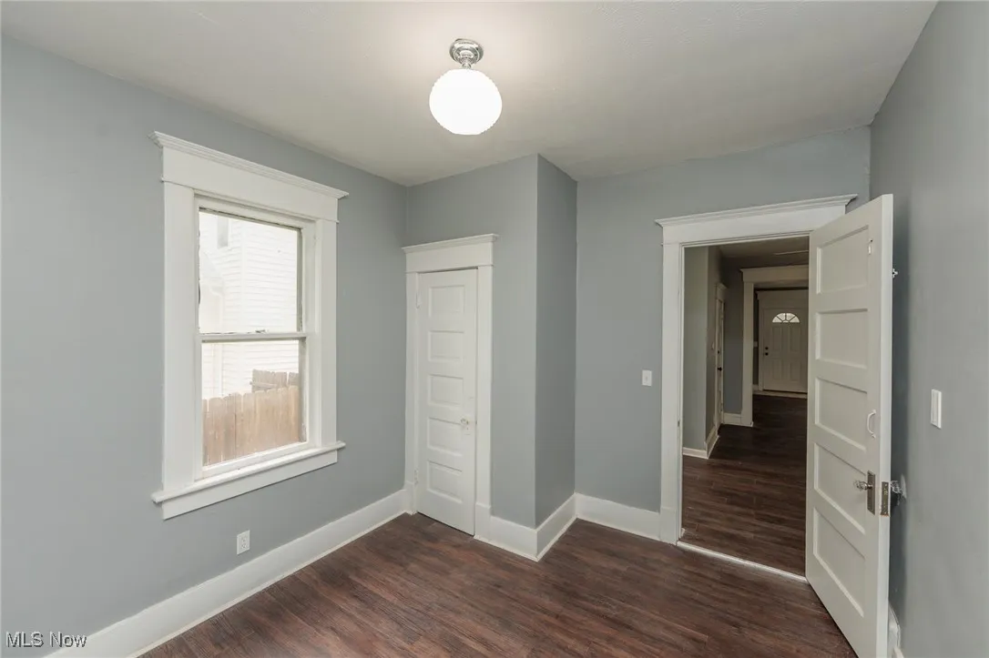 Unfurnished bedroom featuring dark wood finished floors