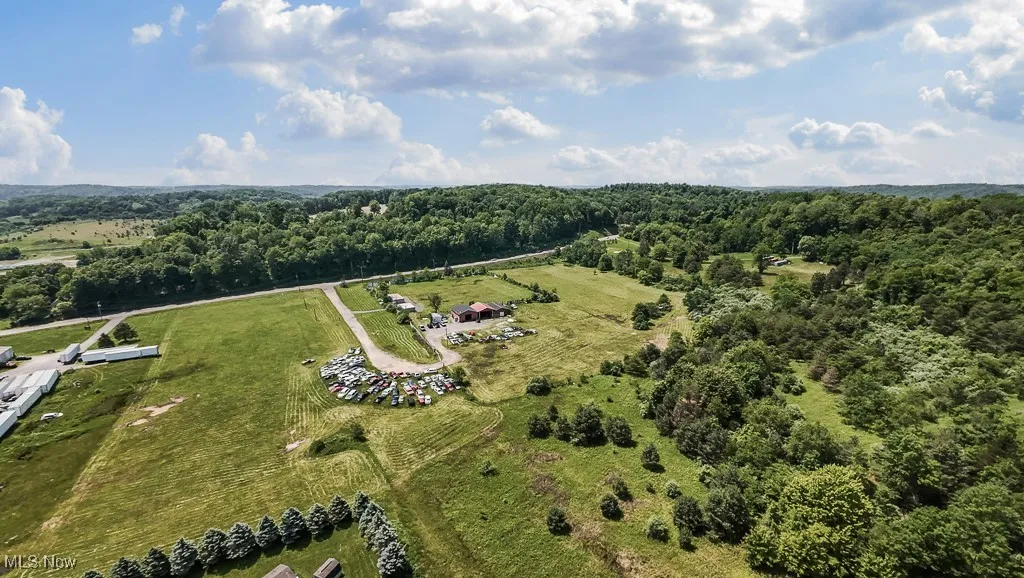 Aerial overview of property's location featuring a forest
