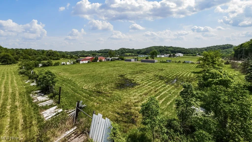 View of yard featuring a view of rural / pastoral area, agricultural plots, and an outdoor structure