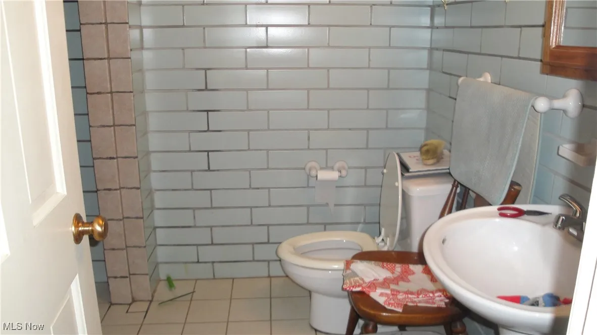 Bathroom with tile walls and tile patterned floors