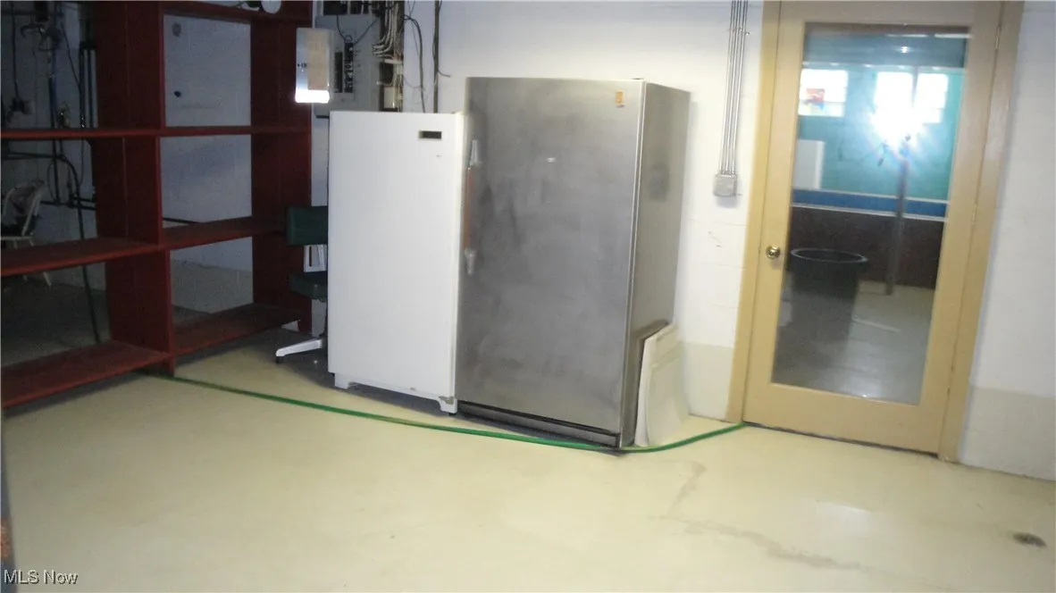 Below grade area with freestanding refrigerator