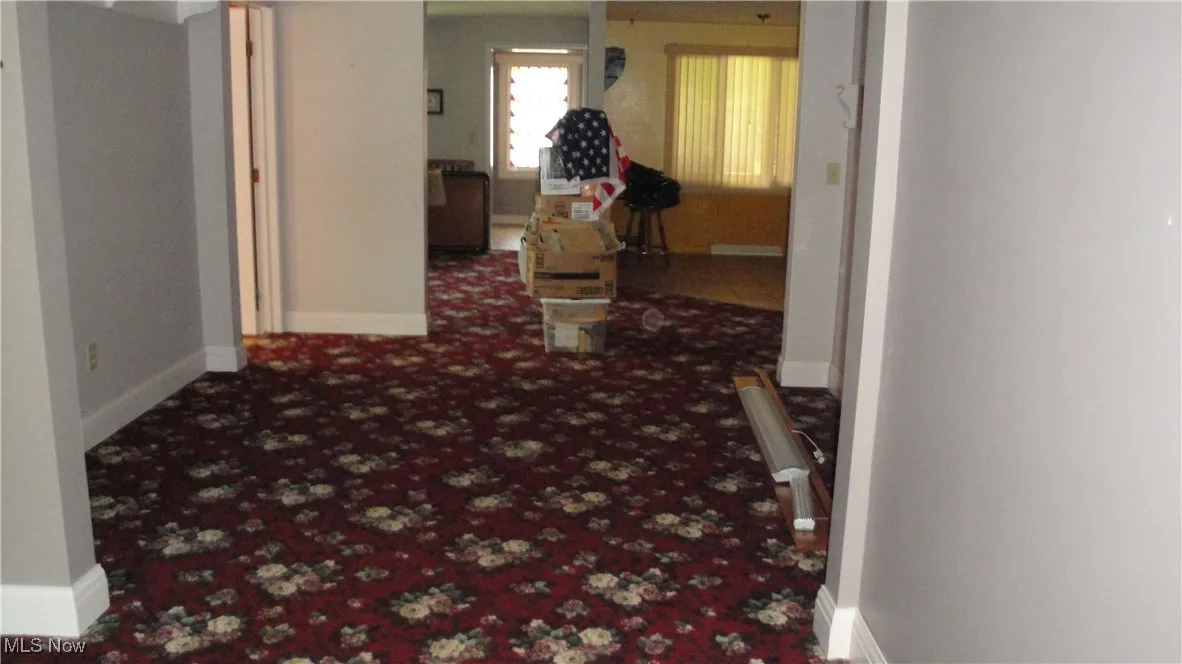 Corridor with carpet floors and baseboards
