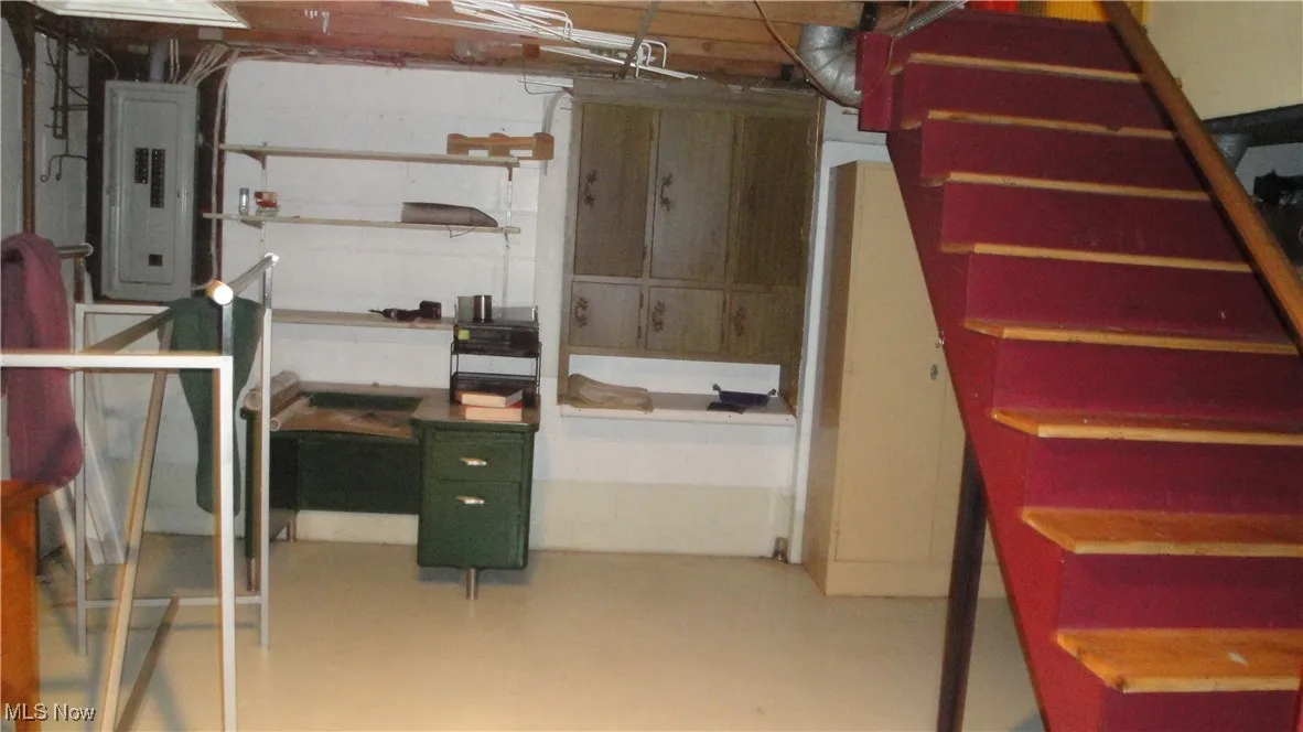 Unfinished basement featuring electric panel
