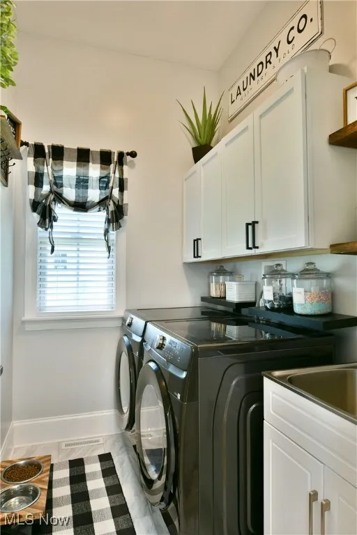 Laundry room featuring cabinet space and washing machine and dryer