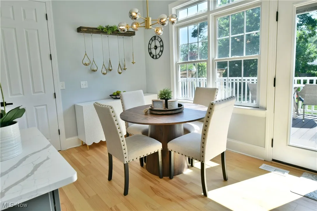 Dining area featuring a chandelier and light wood finished floors