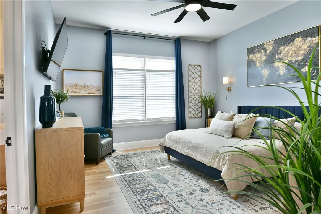 Bedroom featuring light wood-style floors and a ceiling fan